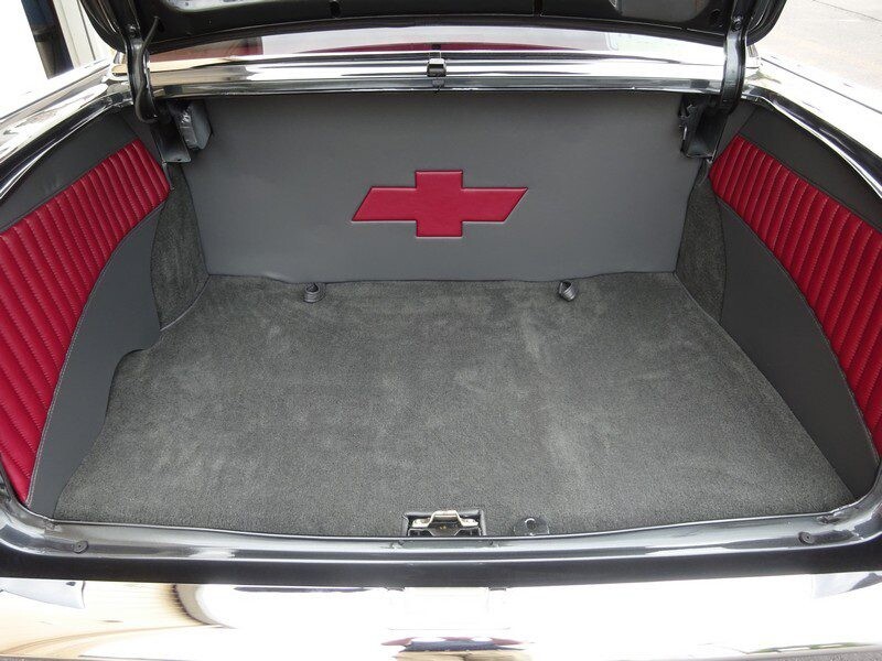 Here's an alt tag for the image: Classic car's custom trunk interior.