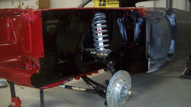 Red classic car undercarriage detail.