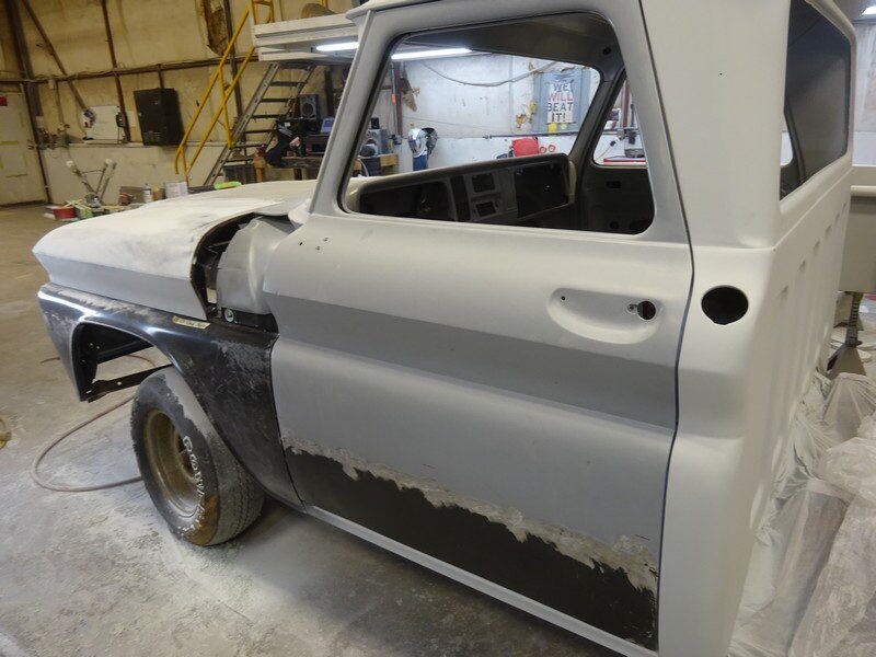 Primered classic truck body undergoing restoration.