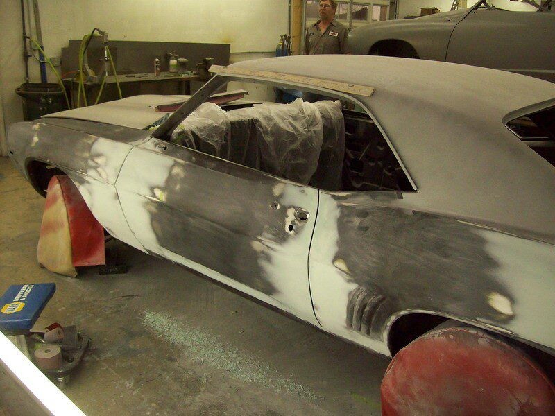 Primered classic car undergoing bodywork.
