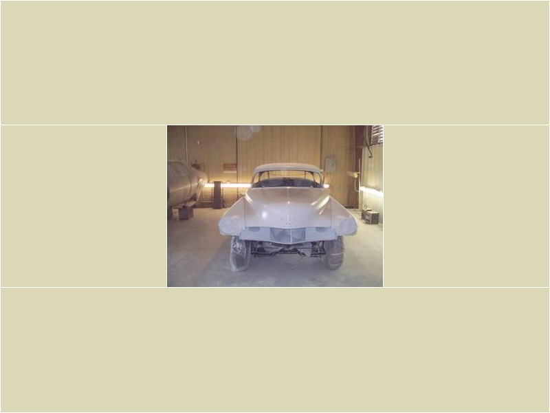 Here's an alt tag for the image: > Classic car in a paint booth.