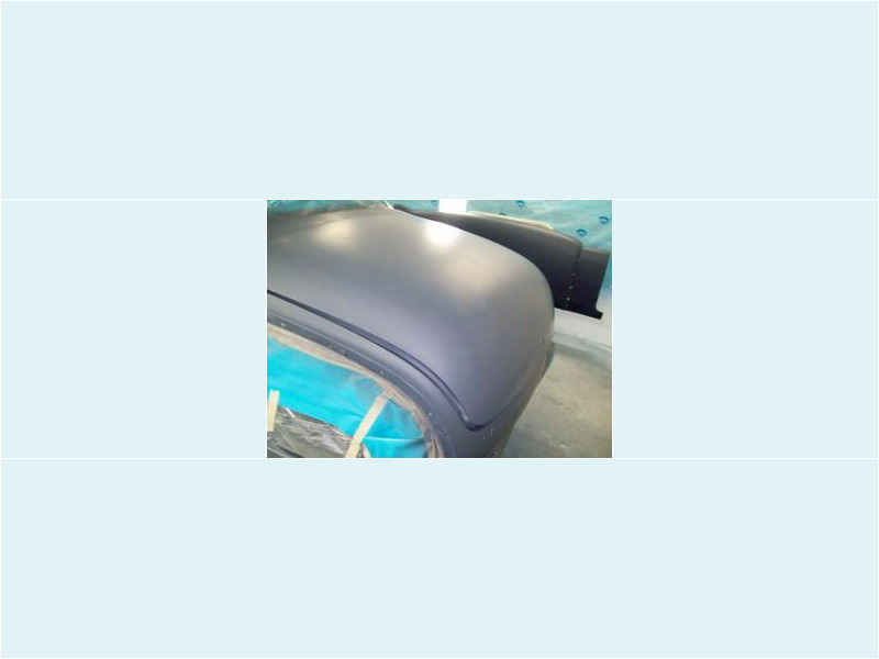 Here's an alt tag for the image: `Matte grey car body panel`