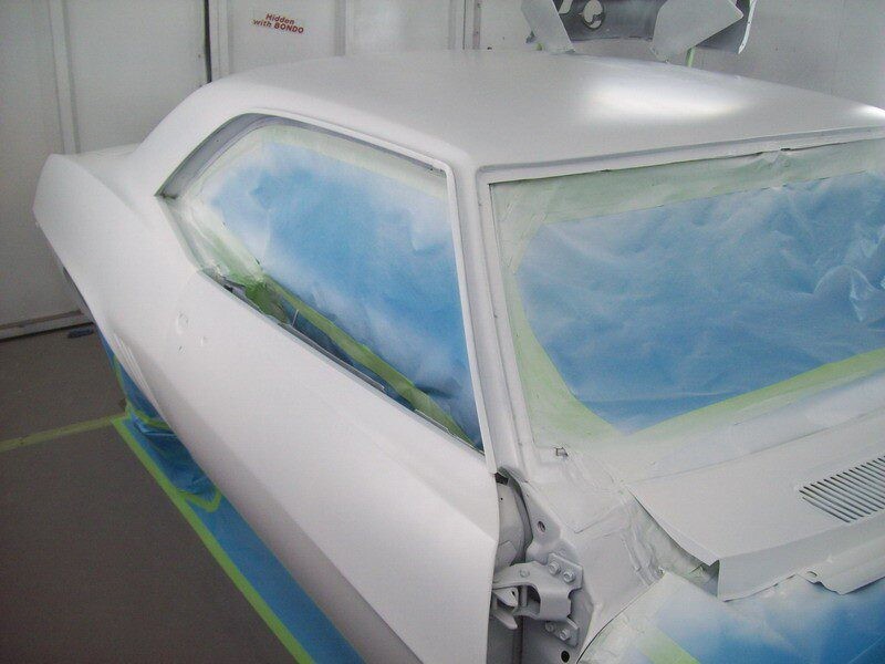 White car body in paint booth.