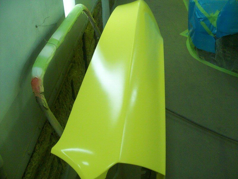 Freshly painted car hood, bright yellow.