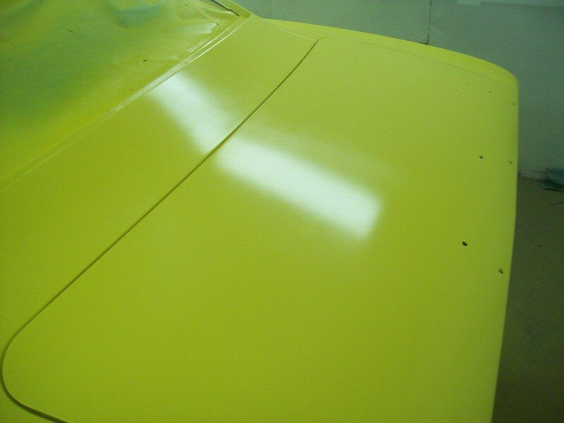 Freshly painted yellow car trunk lid.