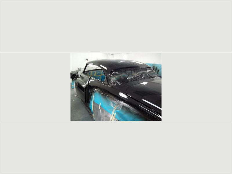 Here's an alt tag for the image: Black classic car, paint job in progress.