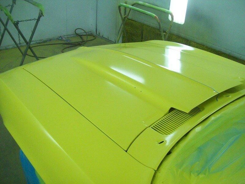 Freshly painted yellow car hood.