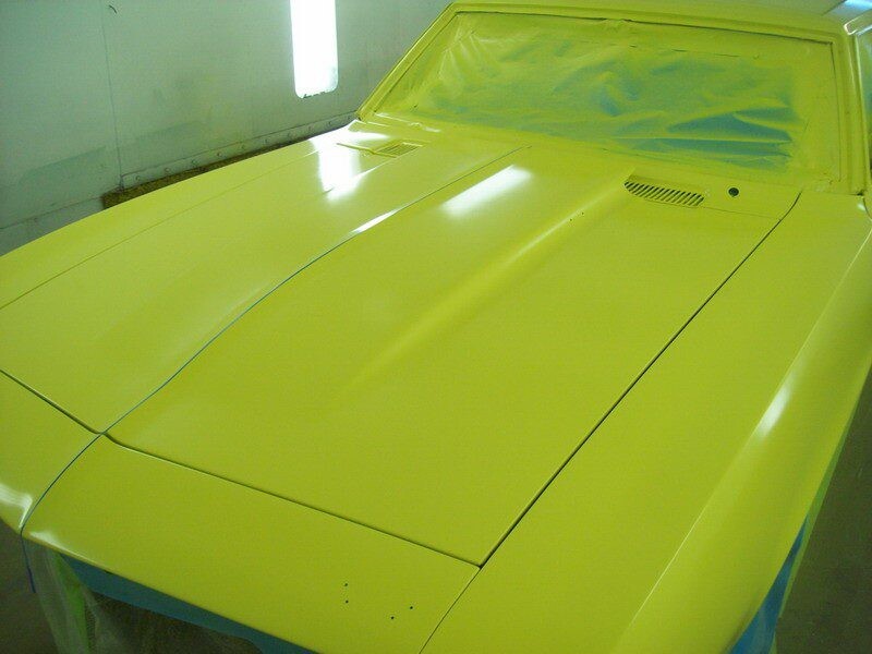 Yellow classic car during paint job.