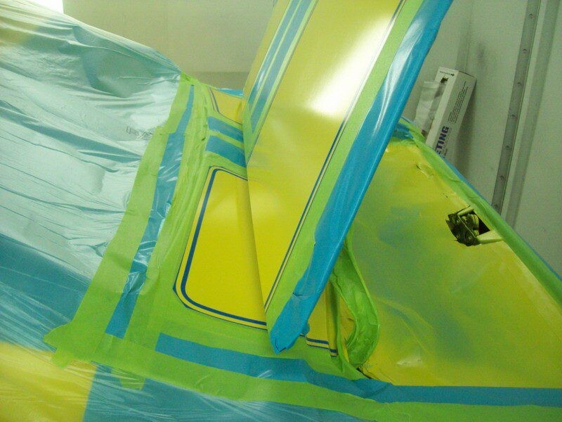 Car body being painted yellow.