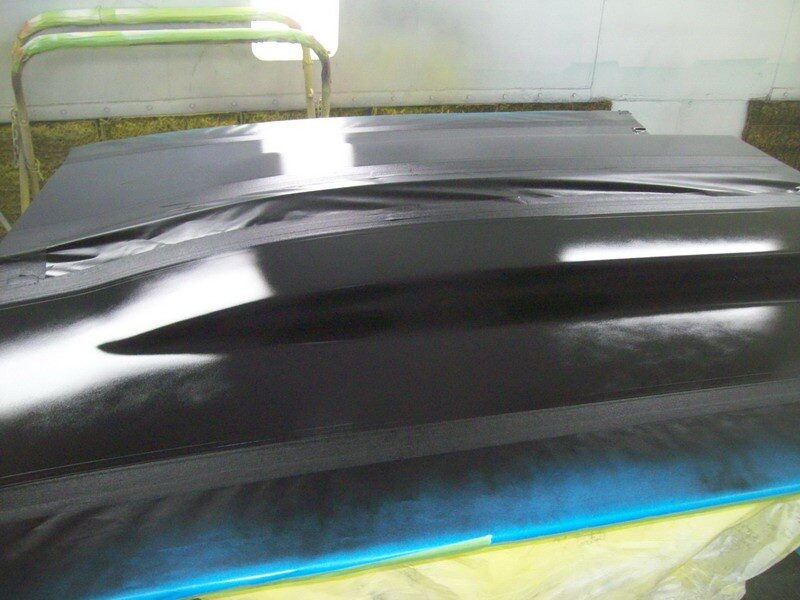 Black car part in paint booth.