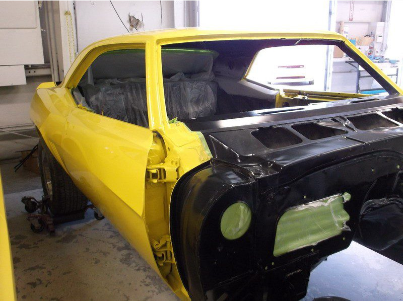 Yellow Camaro restoration in progress.