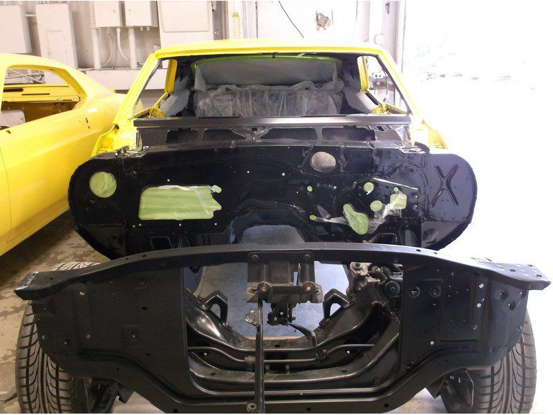 Yellow classic car body restoration.