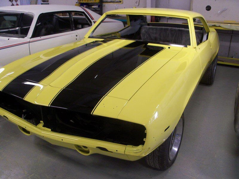 Yellow Camaro with black racing stripes.