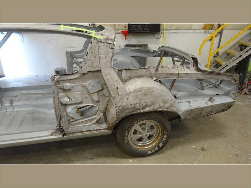 Classic car body restoration in progress.