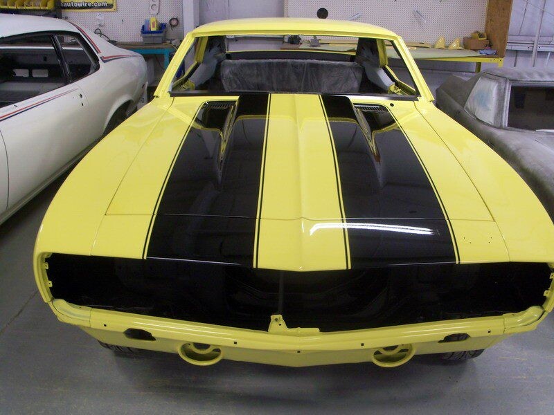 Yellow Camaro with black racing stripes.