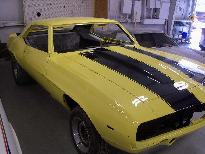Yellow Camaro muscle car restoration.
