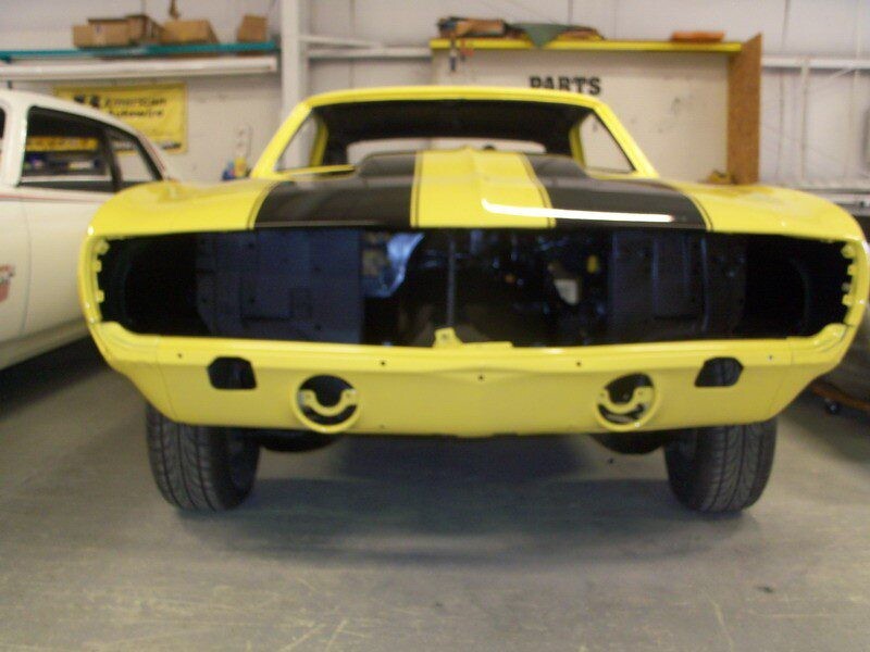 Yellow Camaro muscle car restoration.