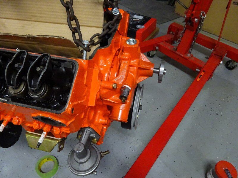 Orange engine block with water pump.