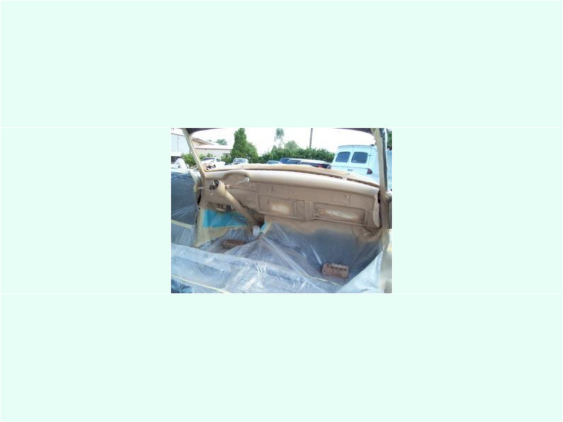Here's an alt tag for the image: `Classic car interior under restoration`