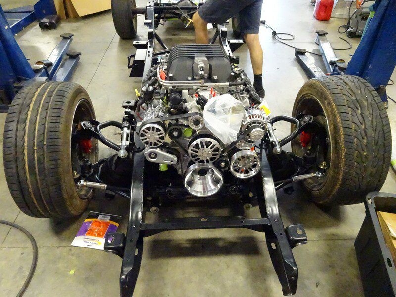 Car engine in chassis under construction.