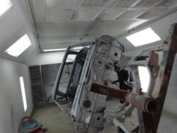 Car body in paint booth preparation.