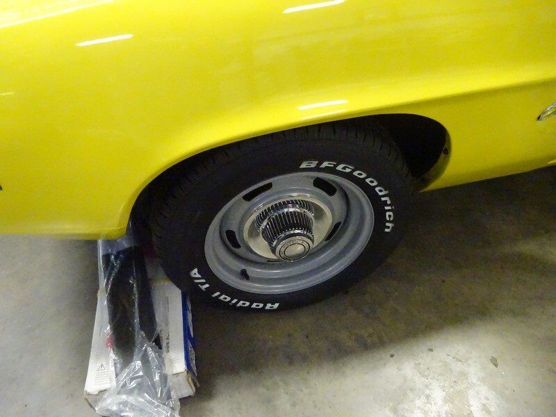 Yellow classic car tire and wheel.