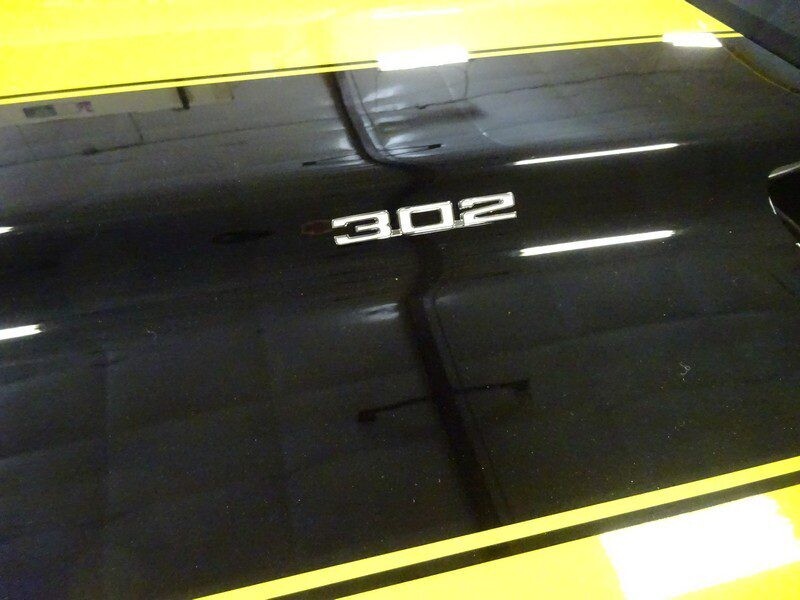 Black car hood with 302 badge.