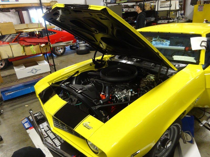 Yellow Camaro engine bay revealed.