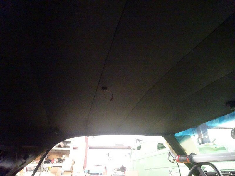 Here's an alt tag for the image: Car headliner, showing damage.