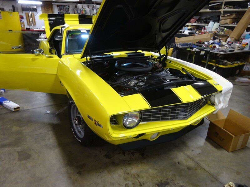Yellow Camaro with hood open.