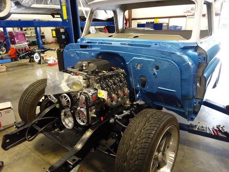 Blue classic truck engine swap in progress.