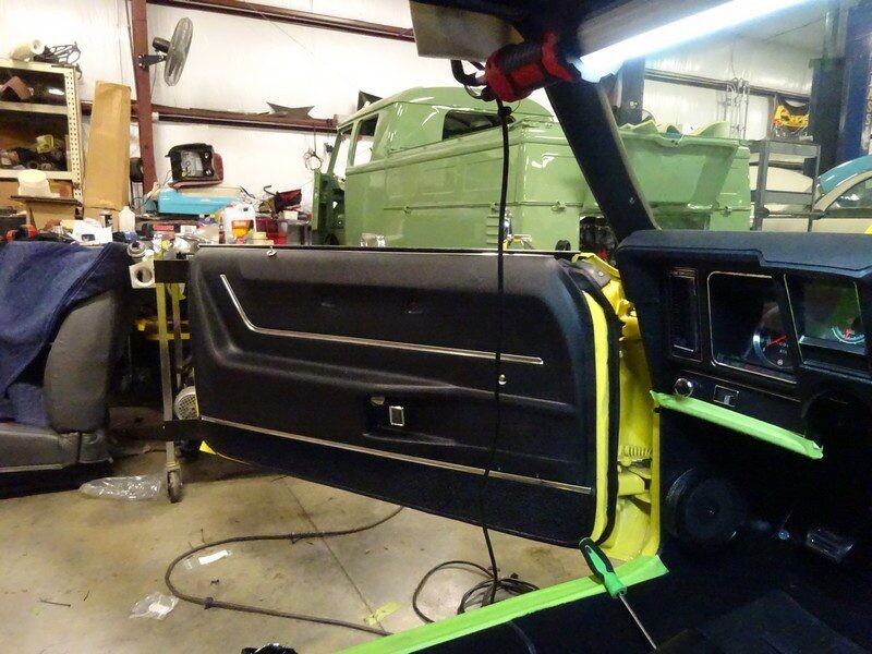 Classic Camaro door panel installation.