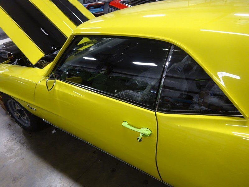 Yellow classic Camaro muscle car.