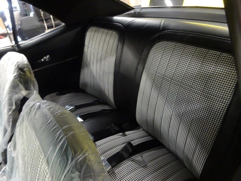 Classic car's houndstooth interior seats.