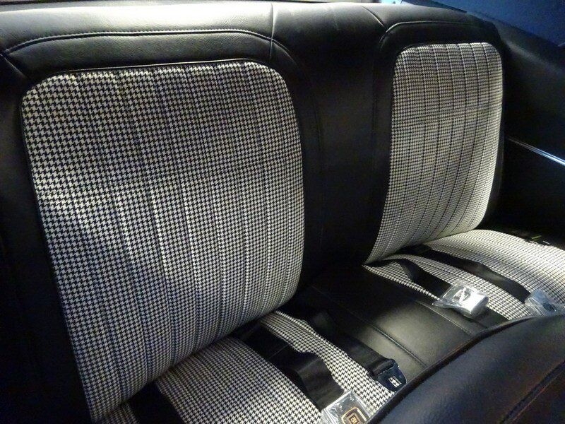 Classic car's houndstooth interior seats.