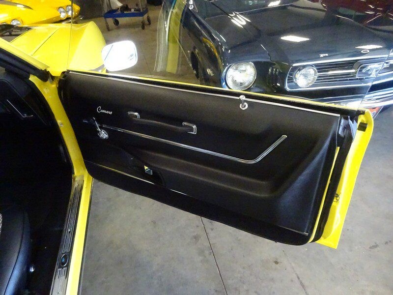 Yellow Camaro interior door panel detail.