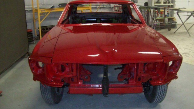 Red classic car body restoration.