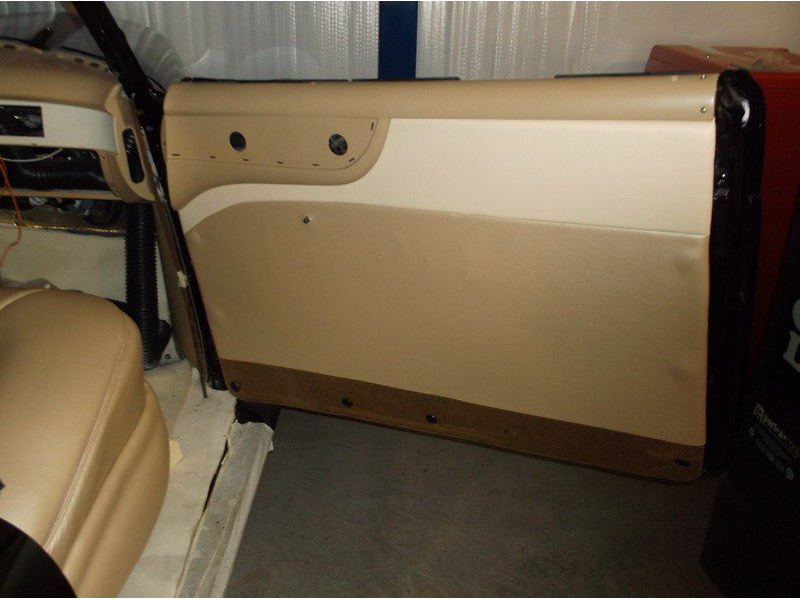 Beige car door panel interior detail.