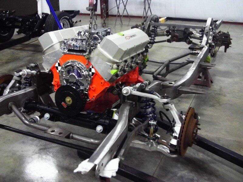 Custom car chassis with engine installed.