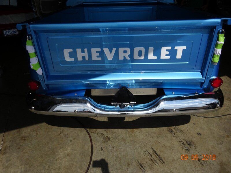 Blue Chevrolet truck rear bumper view.