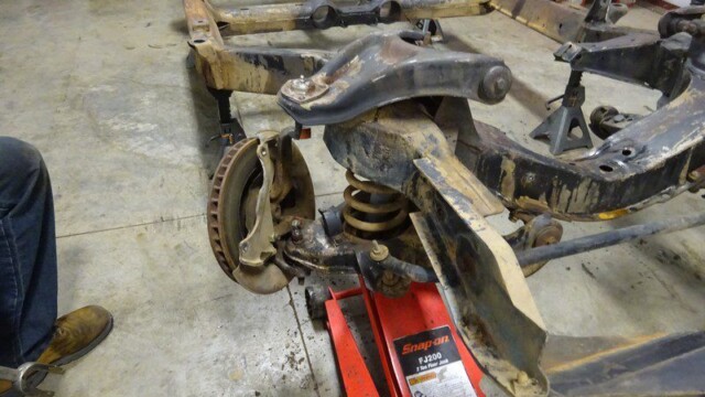 Rusty car frame with disc brake.
