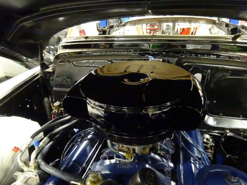 Classic car engine with air cleaner.