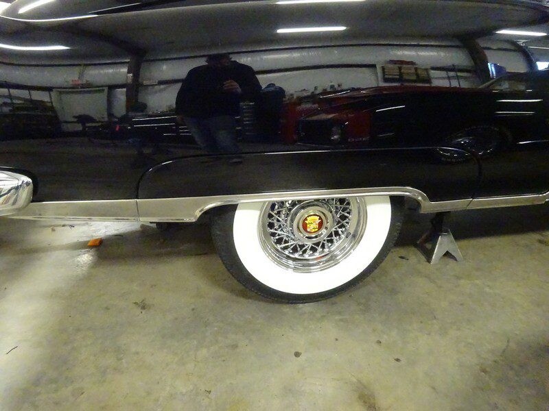 Black classic car's whitewall tire.