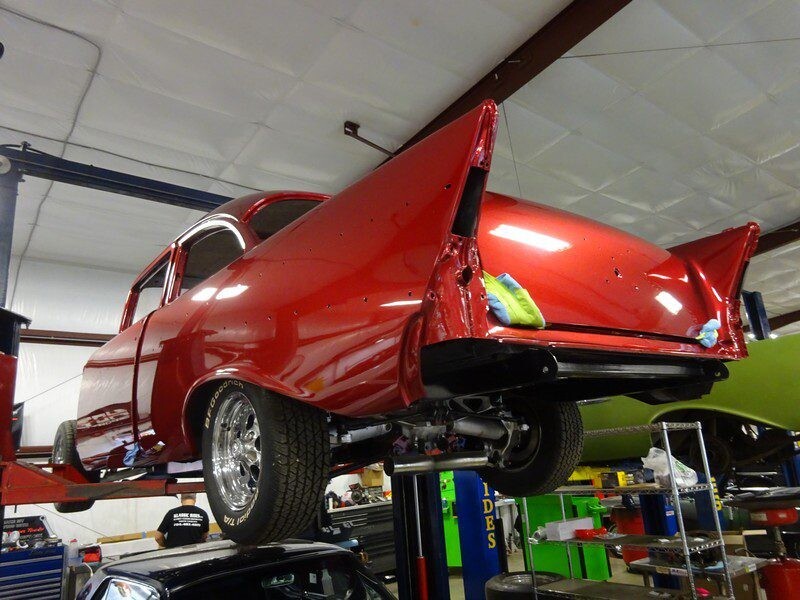 Red classic car in auto shop.
