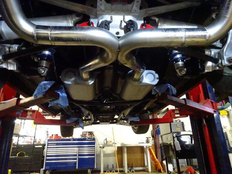 Custom car exhaust system underside view.