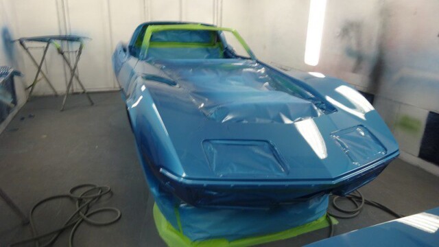 Blue Corvette in paint booth.