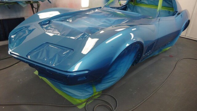 Here's an 8-word alt tag for the image: Blue Corvette during paint job in shop.