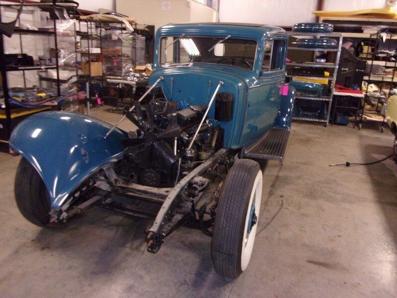 Teal vintage car, under restoration.