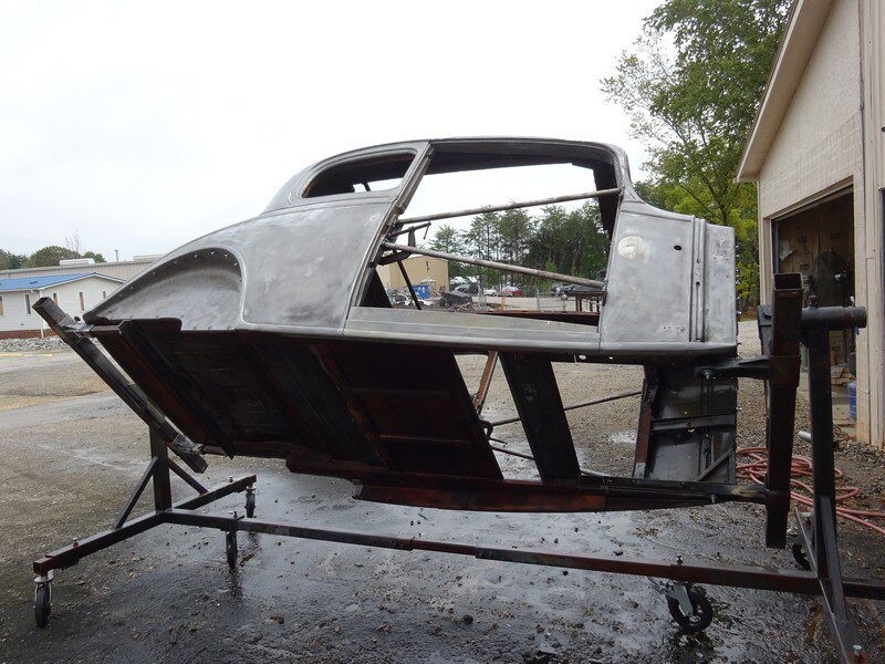 Classic car body shell on stand.