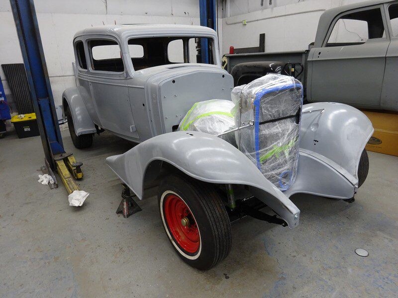 Gray classic car body in restoration.